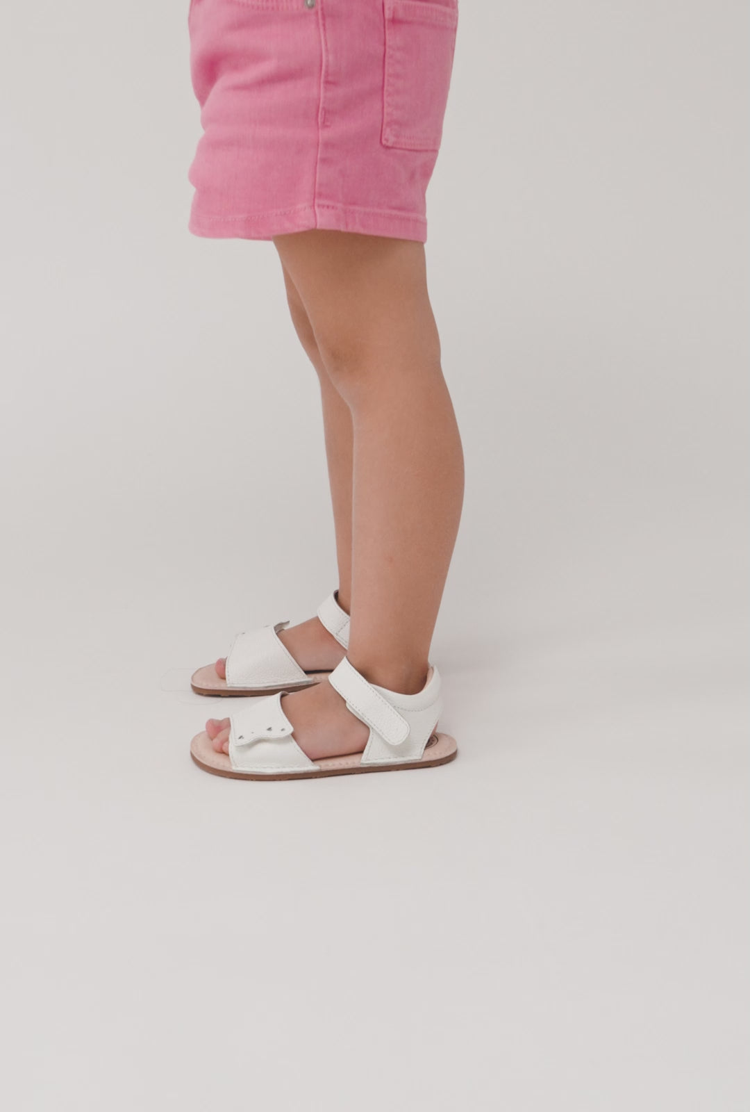 Load video: White Barefoot Heart Sandals for Baby
